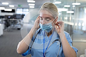 Female health professional wearing face mask at workplace