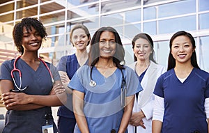 Female healthcare colleagues standing outside hospital