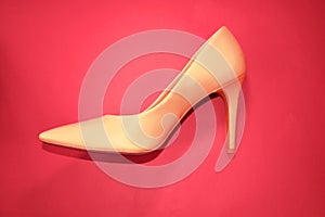 Female heels shoes on a red background photo