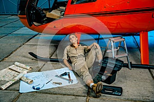 Female helicopter technician tired at work. gender equality.