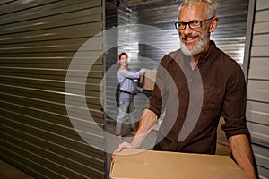 Female helping a man load boxes with things for storage