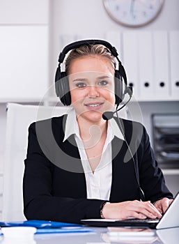 Female helpline operator with headphones