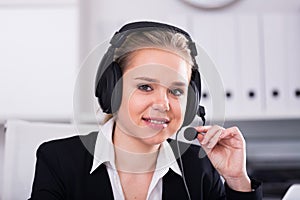 Female helpline operator with headphones