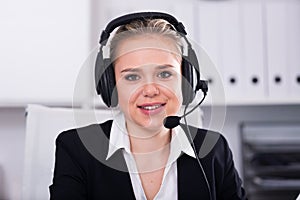 Female helpline operator with headphones