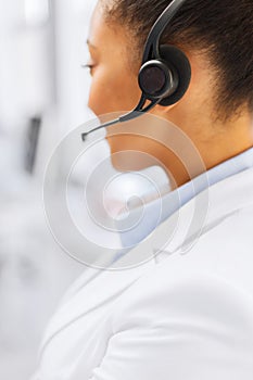 Female helpline operator with headphones