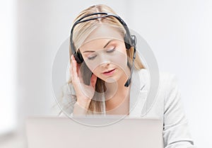 Female helpline operator with laptop photo