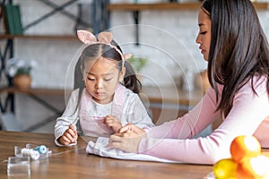 Female and her child involved in hand sewing