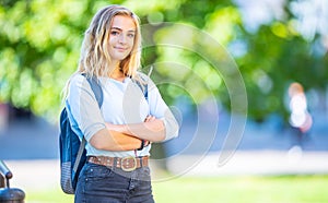 Female high school student with schoolbag. Portrait of attractive young blonde girl