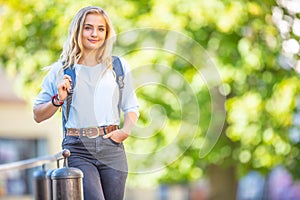 Female high school student with schoolbag. Portrait of attractive young blonde girl