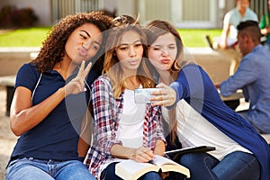 Female High School Students Taking Selfie On Campus