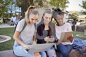 Female High School Students Using Digital Devices Outdoors During Recess