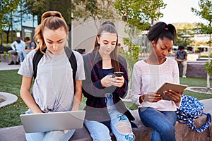 Female High School Students Using Digital Devices Outdoors During Recess