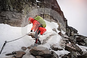 Female hiker climbing up the Rysy mountain