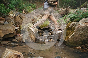 Female hiker crossing a creek