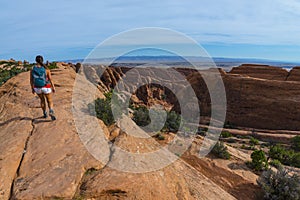 Female hiker on a Devils Garden trail to Double O Arch