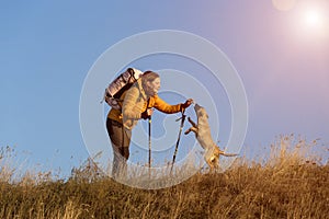 Female hiker and dog on pathway