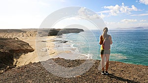 Female hiker enjoying view of Playas de Papagayo beaches in Lanz