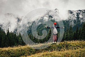 Female hiker feeling free and enjoy mountain nature at autumn