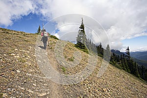 Female hiker heading up mountain path