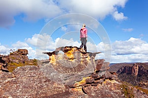 Female hiker high on a mountain pagoda looking at view