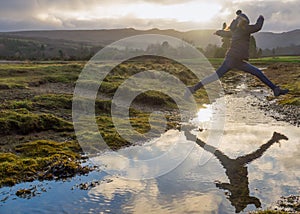 Female Hiker Jumps Stream in Arran Scotland