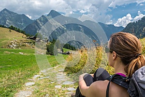 Female hiker relaxing by the road. photo