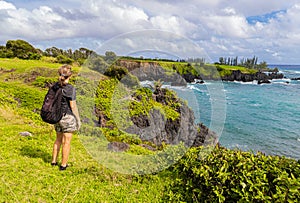 Female Hiker on The Rugged Shoreline Along The Maka Alae Coast