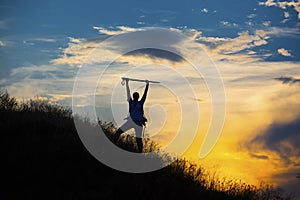 Female hiker silhouette with massive clouds on the