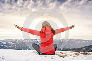 Female hiker on snow covered mountain top