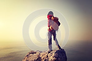 Female hiker stand on the cliff edge