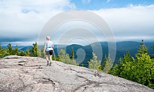 Female hiker at the summit of Mount Jo Lake Placid