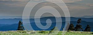 Wide shot of hiker crossing a bald mountain