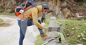 Female hiker tying her laces