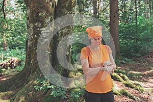 Female hiker using smart wristband during trekking in nature