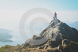 Female hikers on top of the mountain taking a break and enjoying a valley view