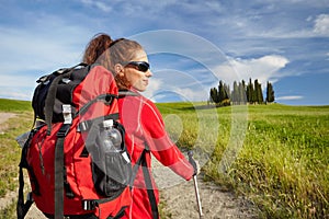 Female hiking woman happy and smiling during hike trek on Toscan