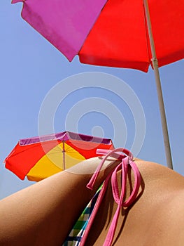 Female hip and beach umbrellas