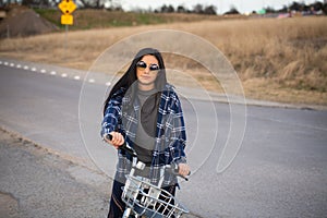 Female Hispanic Teen Riding A Bike