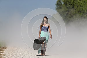 A Female Hitchhikes On A Dirt Road