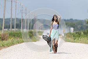 A Female Hitchhikes On A Dirt Road