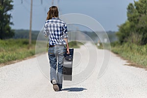 A Female Hitchhikes On A Dirt Road