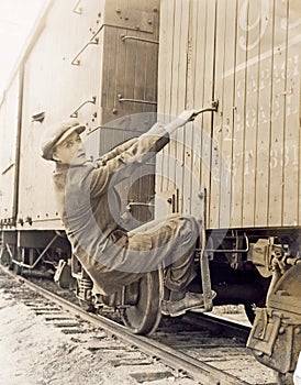 Female hobo climbing freight train photo