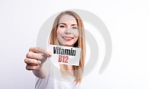 female hold a card with word Vitamin B12 on white