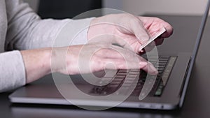 Female holding credit card, paying purchases online, Close-up view