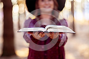 Female holding the open Bible towards the sky