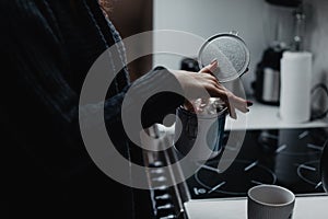 Female holding a tea box and taking tea bag