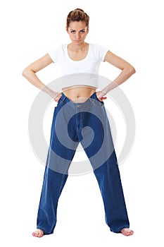 Female holds her old huge jeans, diet concept