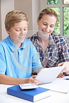 Female Home Tutor Helping Boy With Studies Using Digital Tablet