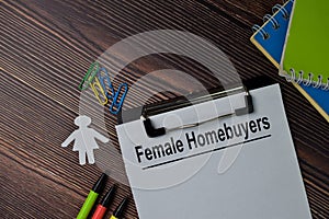 Female Homebuyers text write on paperwork isolated on office desk photo
