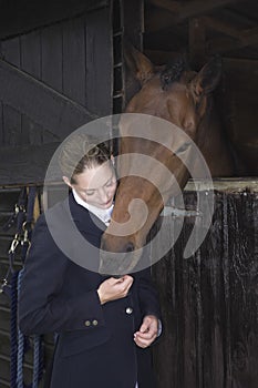 Female Horseback Rider With Horse In Stable